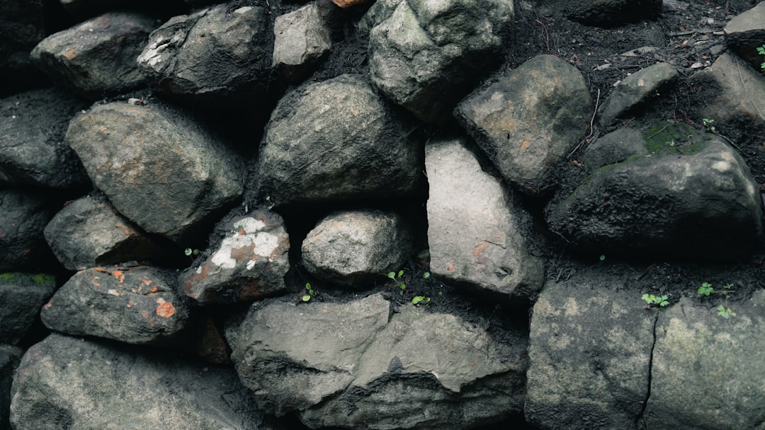 A wall constructed from large, rough stones.
